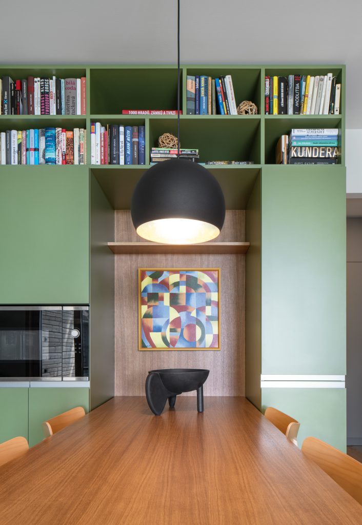 Jídelní kout s knihovnou v interiéru lesní chaty