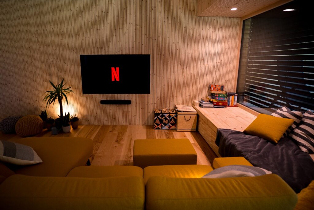 Obývací pokoj s pohledovými CLT panely, rohovou sedačkou a vestavěným sedacím oknem.